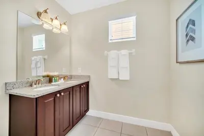 a bathroom with a sink and a mirror at 7503 Marker Avenue in Orlando