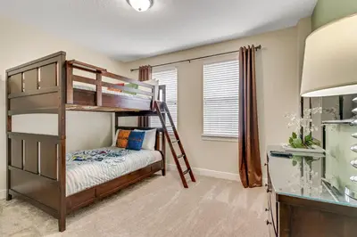 a bedroom with bunk beds and a desk at 7668 Wilmington Loop in Orlando