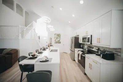 a kitchen with white cabinets and a white counter top at 6BR Family Vacation Home near Disney in Kissimmee