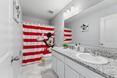 a bathroom with a red and white striped shower curtain at Savvy 4Bed Stay Near Orlando Attractions in Kissimmee