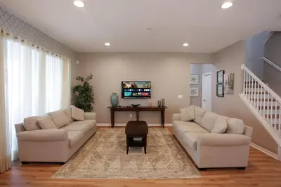 a living room with two couches and a tv at Spacious Home - Veranda Palms w Heated Pool & BBQ in Kissimmee