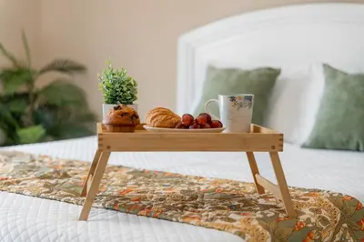 a tray of fruit on a table on a bed at Lakefront Home Game Room & Views in Kissimmee