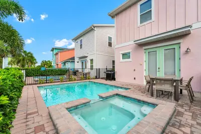 a swimming pool in front of a house at Blush Breeze Cottage Near Disney With Private Pool & Margaritaville Resort And Island H20 Waterpark Access - 2940Sr in Orlando