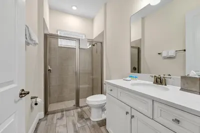 a bathroom with a toilet and a sink and a shower at Blush Breeze Cottage Near Disney With Private Pool & Margaritaville Resort And Island H20 Waterpark Access - 2940Sr in Orlando