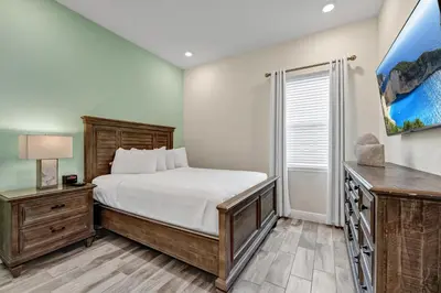 a bedroom with a bed and a desk and a window at Blush Breeze Cottage Near Disney With Private Pool & Margaritaville Resort And Island H20 Waterpark Access - 2940Sr in Orlando