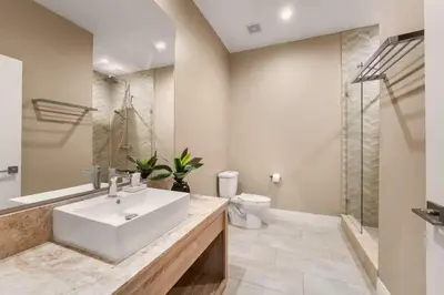a bathroom with a sink and a toilet and a shower at Magic Villa - 4 En-Suite & BBQ Grill in Orlando