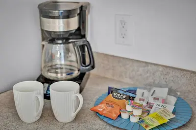a counter with two white cups and a blender at Spacious Emerald Home with Pool Lanai Near Disney in Kissimmee