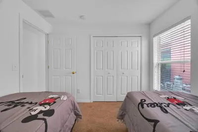 a bedroom with two beds with hello kitty on them at Spacious Emerald Home with Pool Lanai Near Disney in Kissimmee