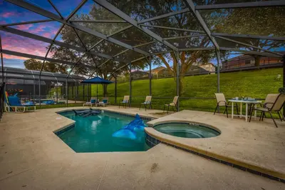 a swimming pool with a blue shark in the water at Spacious Emerald Home with Pool Lanai Near Disney in Kissimmee
