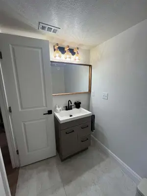 a bathroom with a sink and a mirror at Cozy Ground Floor Studio Near Disney in Kissimmee