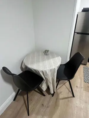 a table and two chairs in a room at Cozy Ground Floor Studio Near Disney in Kissimmee