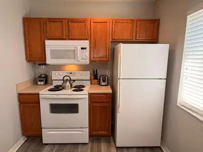 a kitchen with a white refrigerator and a white microwave at 4 Bedroom 3 Bathroom Villas At Seven Dwarfs 24-101 in Kissimmee