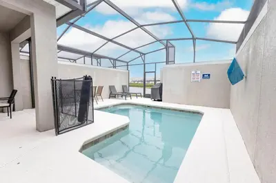 a swimming pool in a building with a glass ceiling at 4BR Townhome w Pool in Storey Lake - Near Disney in Kissimmee