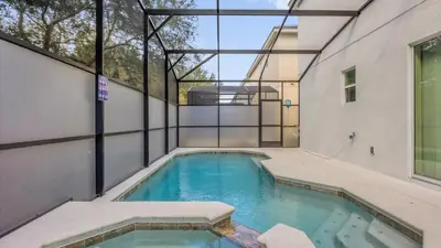an indoor swimming pool in the side of a building at Upstay Spacious Villa w Pool, Hot Tub & Game Room in Kissimmee