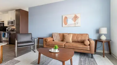 a living room with a couch and a table at Landing Stunning 1BD Gym Clubhouse in Orlando