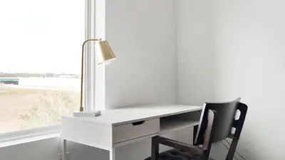a white desk with a chair next to a window at Landing Stunning 1BD Gym Clubhouse in Orlando