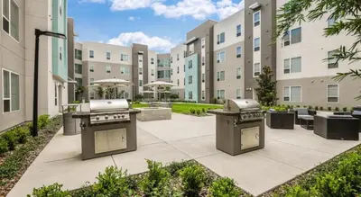 a courtyard with a grill in a building at Landing Stunning 1BD Gym Clubhouse in Orlando