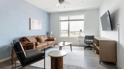 a living room with a couch and a table at Landing Stunning 1BD Gym Clubhouse in Orlando