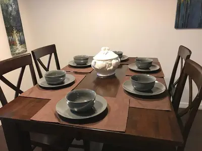 a wooden table with a vase on top of it at 10min to Disney parks new condo free wifi & pool in Kissimmee