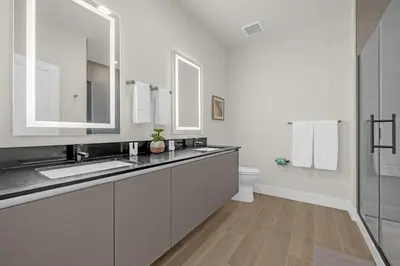 a white bathroom with a sink and a toilet at Luxury 4 Bedroom Family Getaway w Private Pool in Orlando