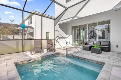 a swimming pool in the backyard of a house at Luxury 4 Bedroom Family Getaway w Private Pool in Orlando