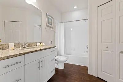 a white bathroom with a sink and a toilet at Townhome 4Q no West Lucaya — 15min Disney in Kissimmee