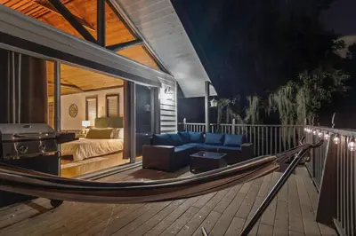 a hammock in a room with a bed and a bedroom at Romantic Getaway Cabin with Jacuzzi in Kissimmee