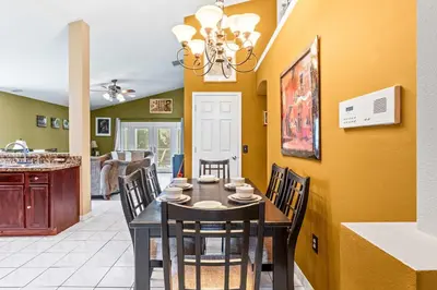 a dining room with a table and chairs at The Art House Home for 8 in Orlando