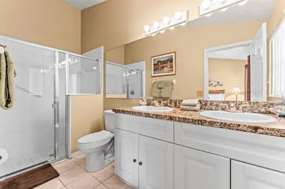 a bathroom with two sinks and a shower and a toilet at The Art House Home for 8 in Orlando