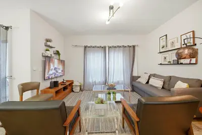 a living room with a couch and a table at Cozy Home Luxury 04 Bedrooms At Storey Lake in Kissimmee