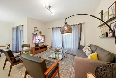 a living room with a couch and a table at Cozy Home Luxury 04 Bedrooms At Storey Lake in Kissimmee