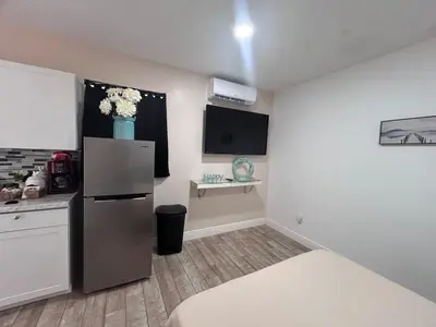 a kitchen with a refrigerator and a counter top at Private Guesthouse in Orlando