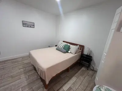 a bedroom with a bed with pillows on it at Private Guesthouse in Orlando