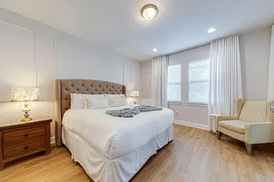 a bedroom with a large bed and a chair at ECR7609 - 6B Enchanted Vacation Home @Encore in Orlando