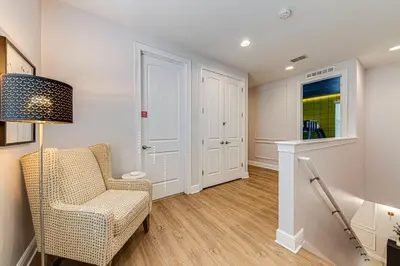 a living room with a chair and a lamp at ECR7609 - 6B Enchanted Vacation Home @Encore in Orlando