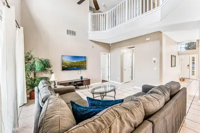 a large living room with a large couch at Luxury 8-Bed Villa Near Disney With Pool & More in Kissimmee