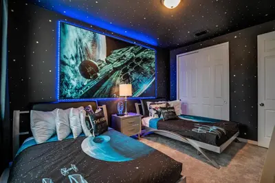 a bedroom with a star wars mural on the wall at Ev1810 - Solara Galaxy Villa in Orlando