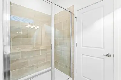 a shower with a glass door in a bathroom at Ev2440 - Orlando Luxe Retreat in Kissimmee