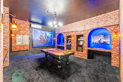 a room with a pool table and a brick wall at Ev2440 - Orlando Luxe Retreat in Kissimmee
