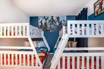 two white bunk beds in a room with blue walls at Ev2619 - Sonoma Retreat in Kissimmee