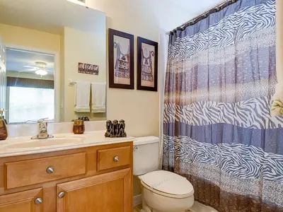 a bathroom with a toilet and a shower curtain at Ev2753 - Golden Horizon Villa in Kissimmee