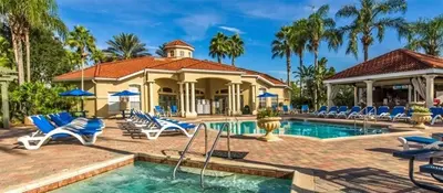 a swimming pool with chairs and a house at Ev2753 - Golden Horizon Villa in Kissimmee