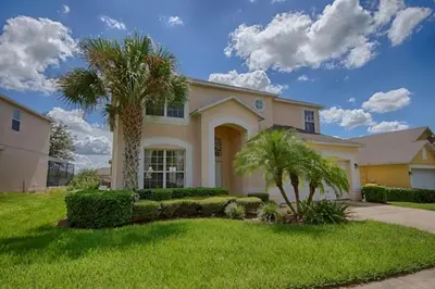 a large house with palm trees in a yard at Ev2753 - Golden Horizon Villa in Kissimmee