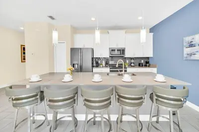 a kitchen with a large island with bar stools at Ev4829 - Lullaby Oasis in Kissimmee