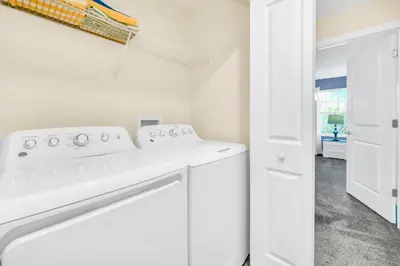 a white laundry room with a washer and dryer at Ev4829 - Lullaby Oasis in Kissimmee