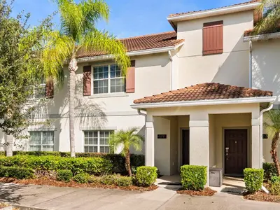 a house with palm trees in front of it at Ev4891 - Harmony Haven Retreat in Kissimmee