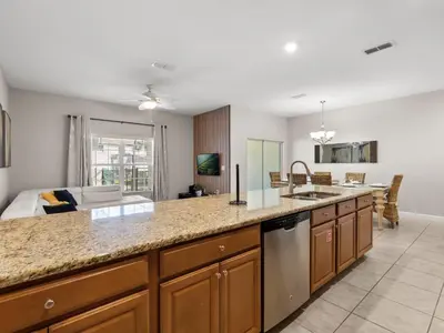 a kitchen with a counter top and a living room at Ev4891 - Harmony Haven Retreat in Kissimmee