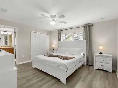 a white bedroom with a bed and a ceiling fan at Ev4891 - Harmony Haven Retreat in Kissimmee