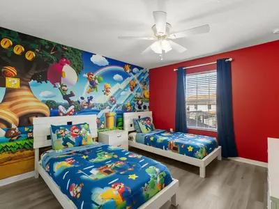 a bedroom with two beds and a disney mural at Ev4891 - Harmony Haven Retreat in Kissimmee