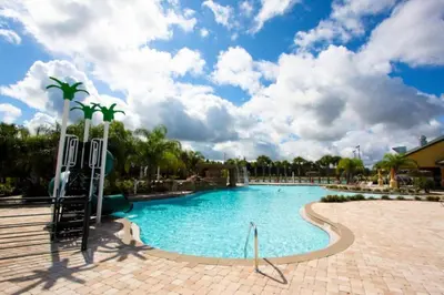 a large swimming pool in a resort under a cloudy sky at Ev8944 - Paradise Palms Escape in Kissimmee